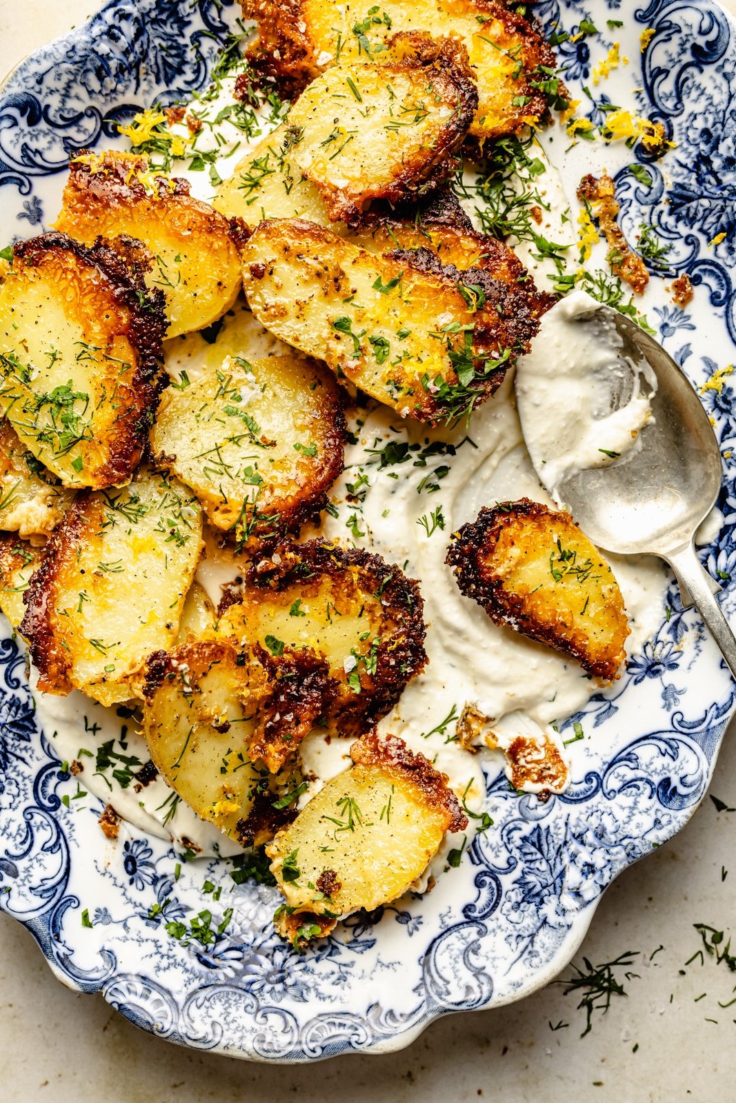 parmesan roasted potatoes in a bowl with garlic feta dip